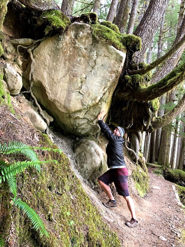 Dave showing strength holding up a large stone